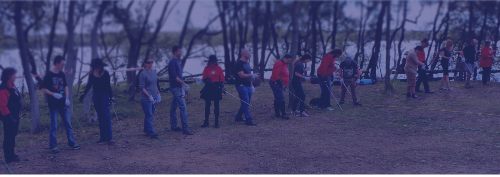 People standing in a line practicing with swords
